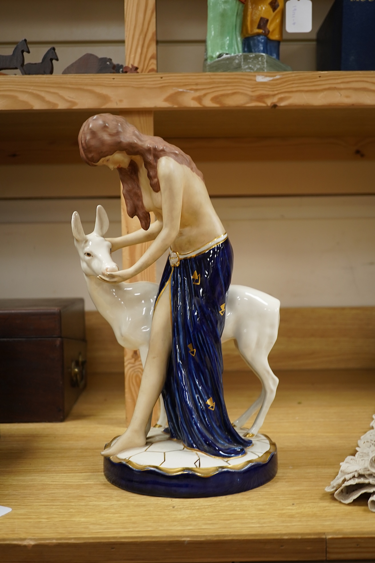 A Royal Dux Art Deco porcelain group of girl with a deer 37.5cm high
